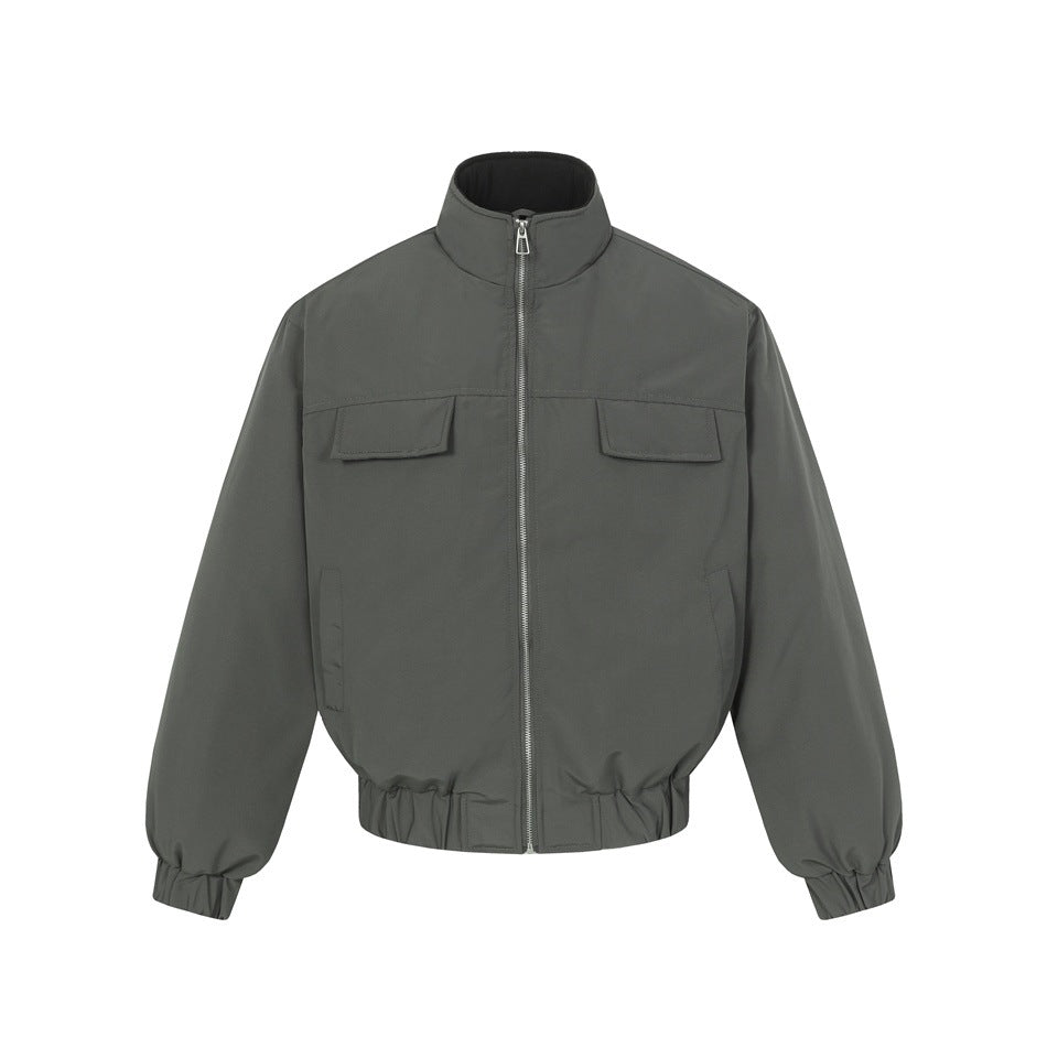 Dark gray stand-collar bomber jacket, front view, with silver zipper, chest flap pockets and elastic cuffs and hem