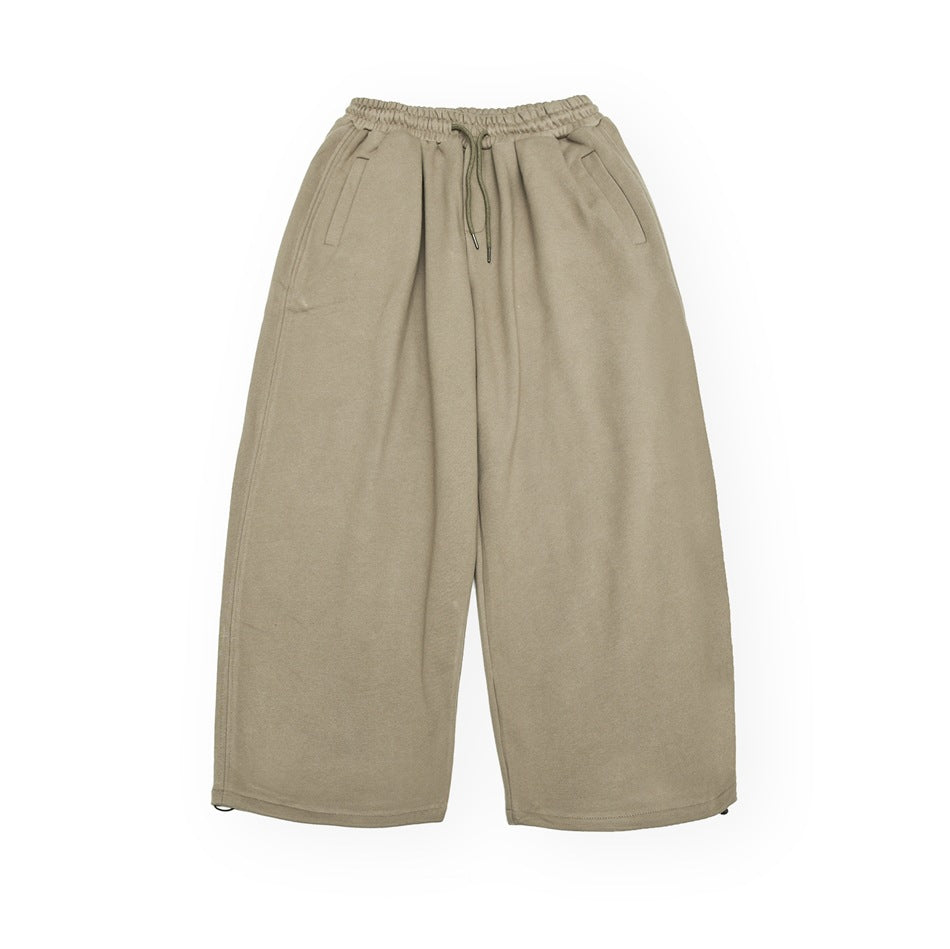 Khaki wide-leg drawstring pants with elastic waist and side pockets, flat lay front view