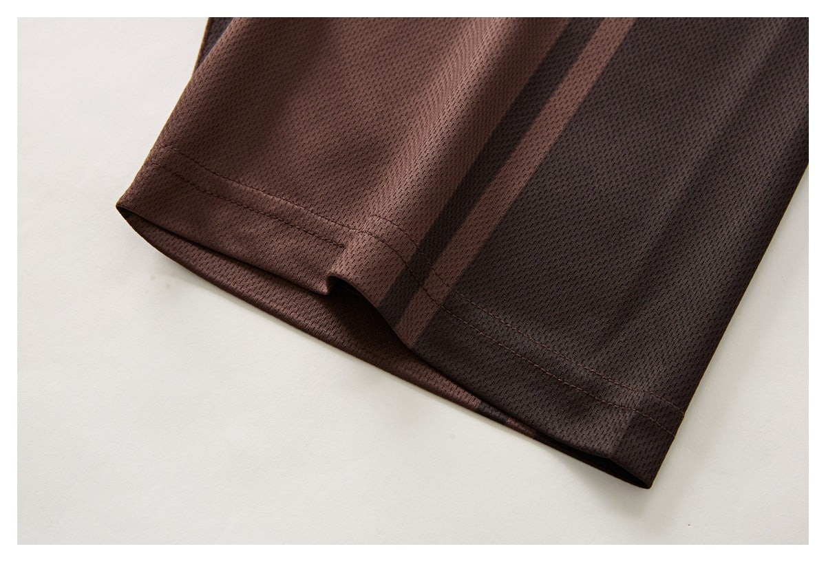 Close-up of a brown striped polo sleeve cuff and stitched hem.