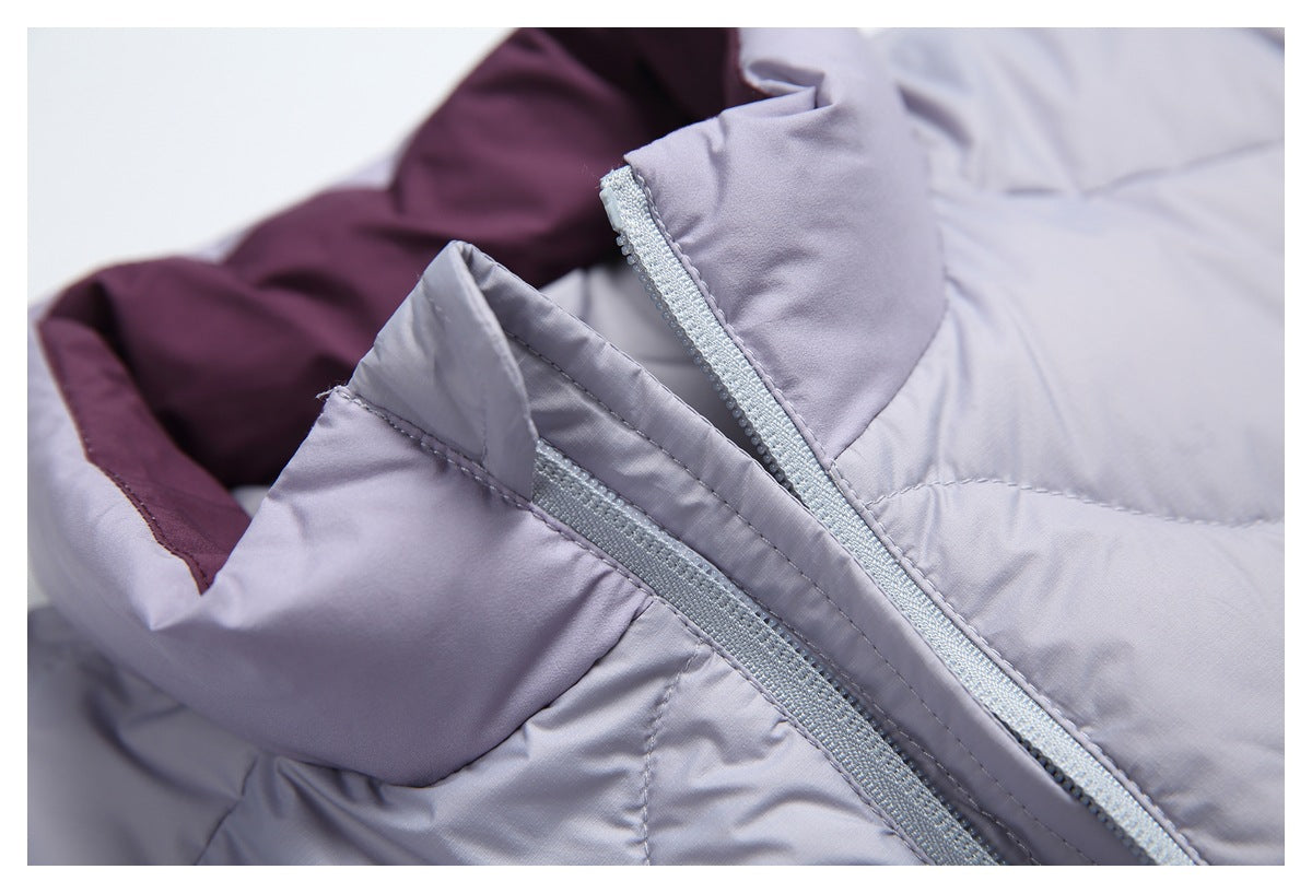 Close-up of a pale lavender-gray quilted jacket showing its zipper and dark plum lining.