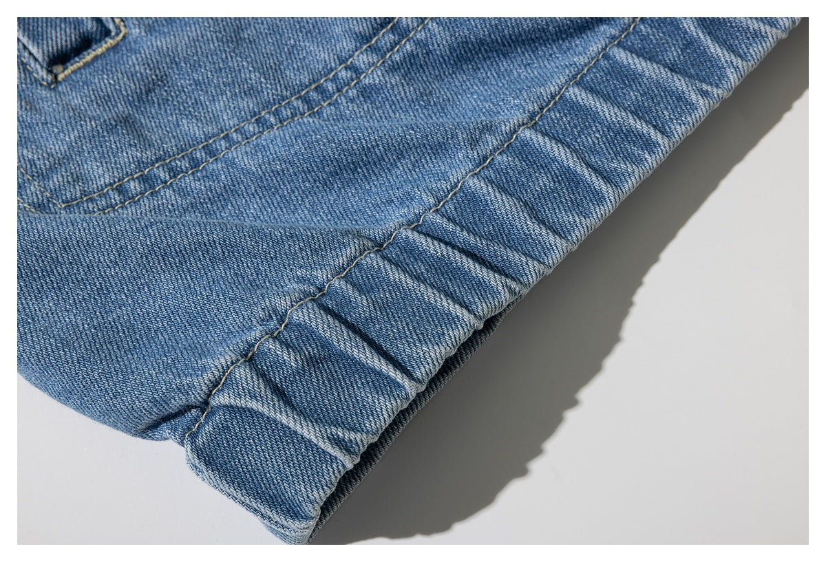 Close-up of a folded edge and double-stitched seam on blue denim.