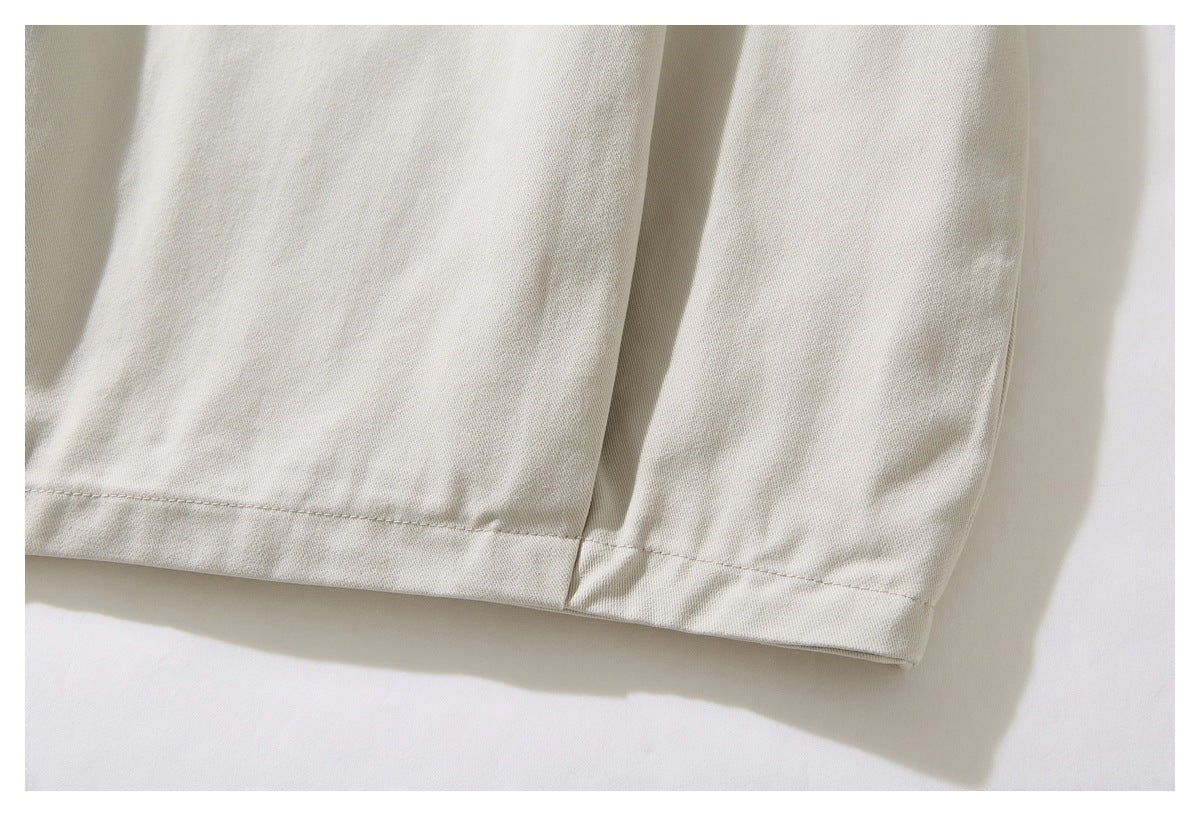 Close-up of the stitched hem and seam on an ivory jacket sleeve.