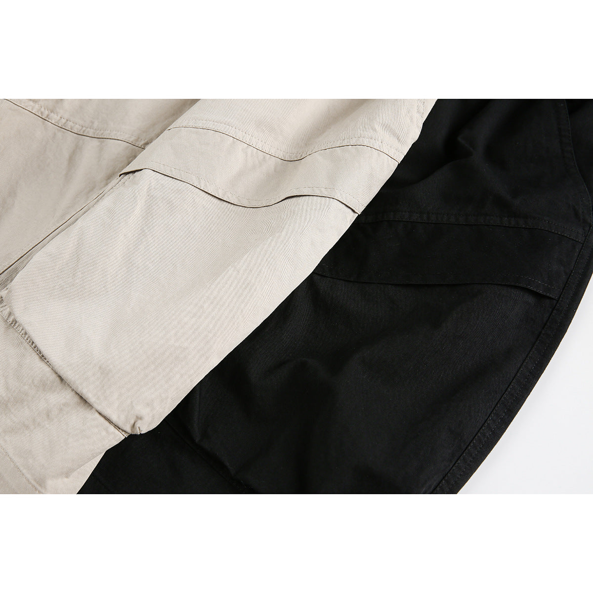 Close-up of beige and black shorts showing stitched cargo-pocket panels.