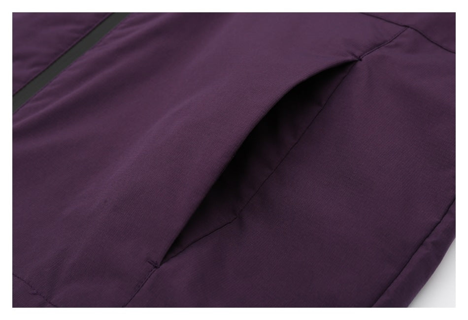 Close-up of an open side pocket on a purple garment, with a black zipper nearby.