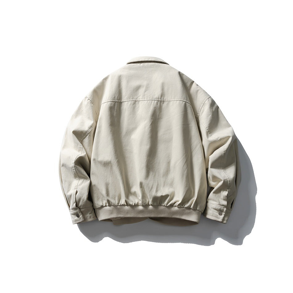 Off-white jacket back view showing yoke seam, ribbed hem band and snap cuffs