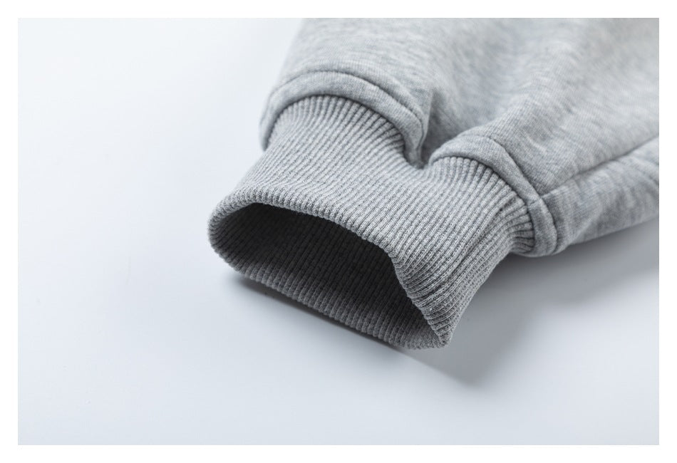 Close-up of a ribbed cuff on the sleeve of a heather gray hoodie.