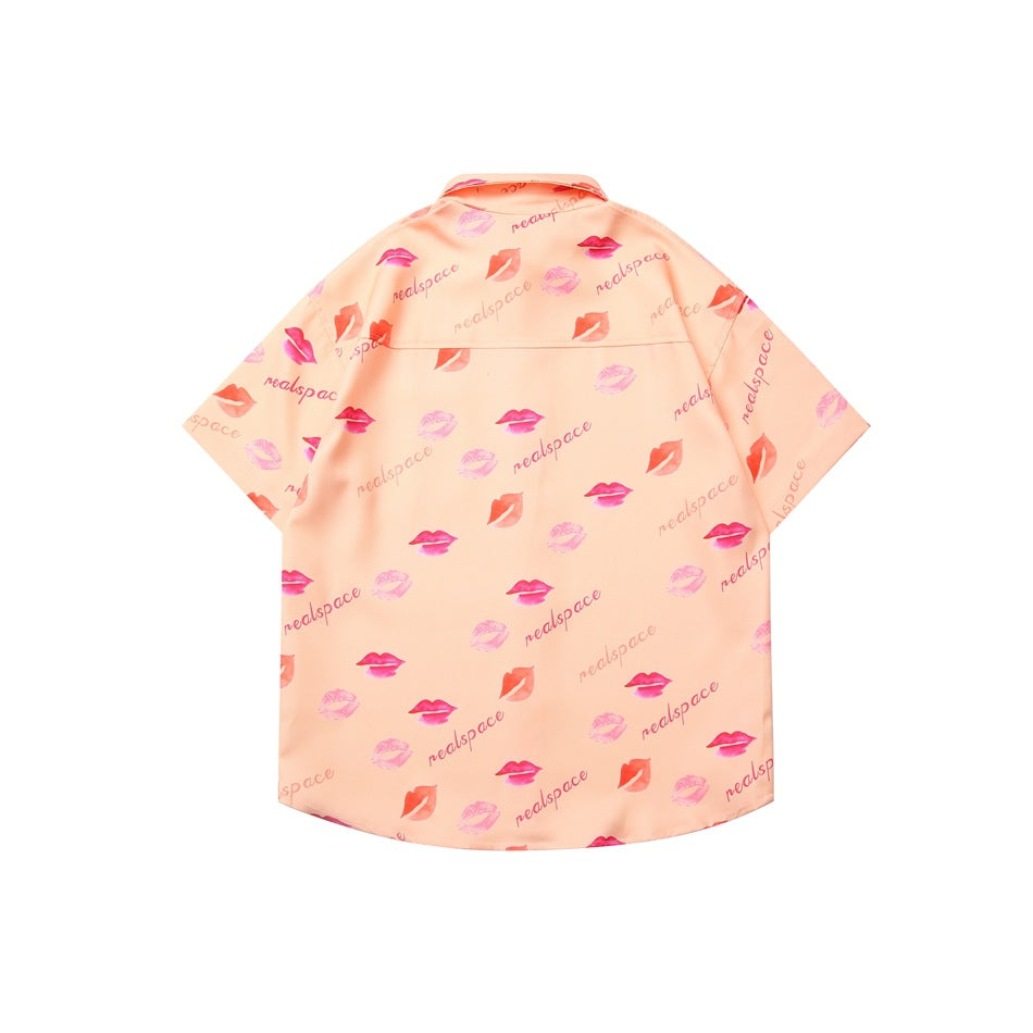 Back view of a peach short-sleeve button-up shirt with an all-over lipstick print and lettering.