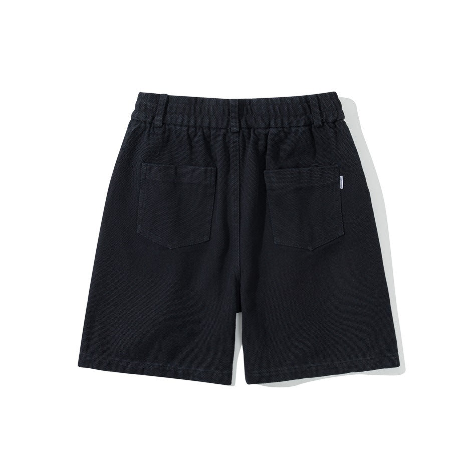 Back view of black shorts with elastic waistband and two patch back pockets
