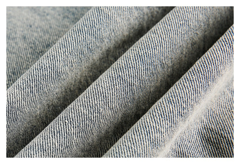 Close-up of light-wash denim fabric showing its diagonal weave and texture.