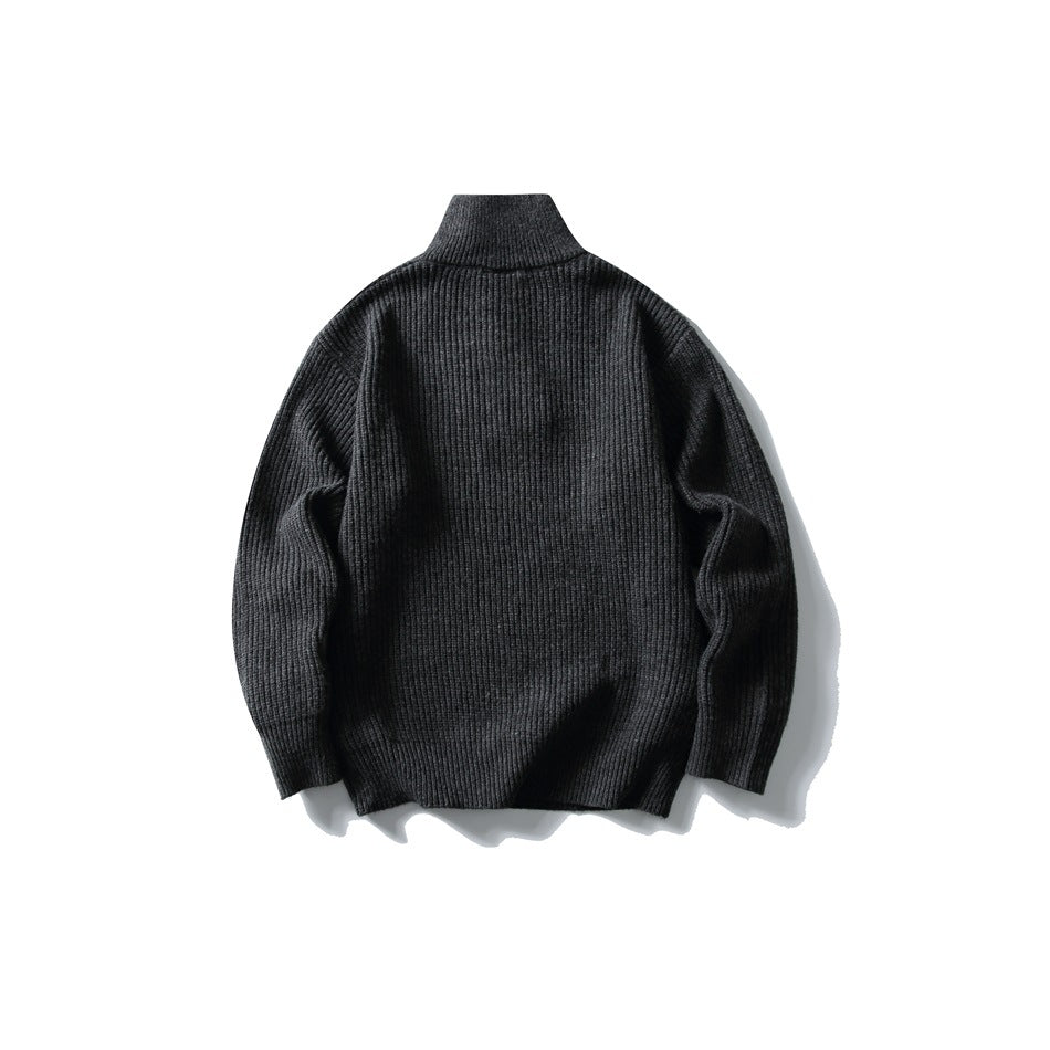 Dark gray ribbed knit sweater with stand collar, flat lay back view