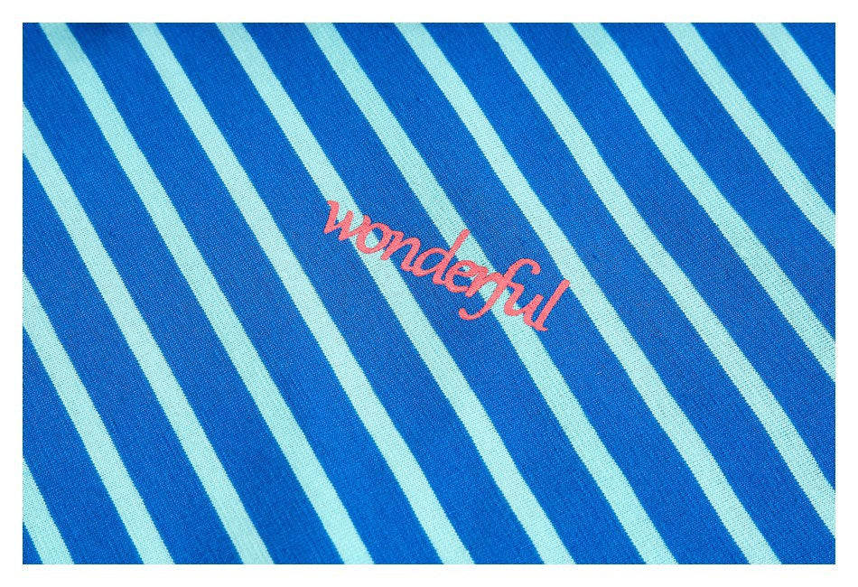 Close-up of blue and pale aqua diagonal stripes with pink “Wonderful” lettering.