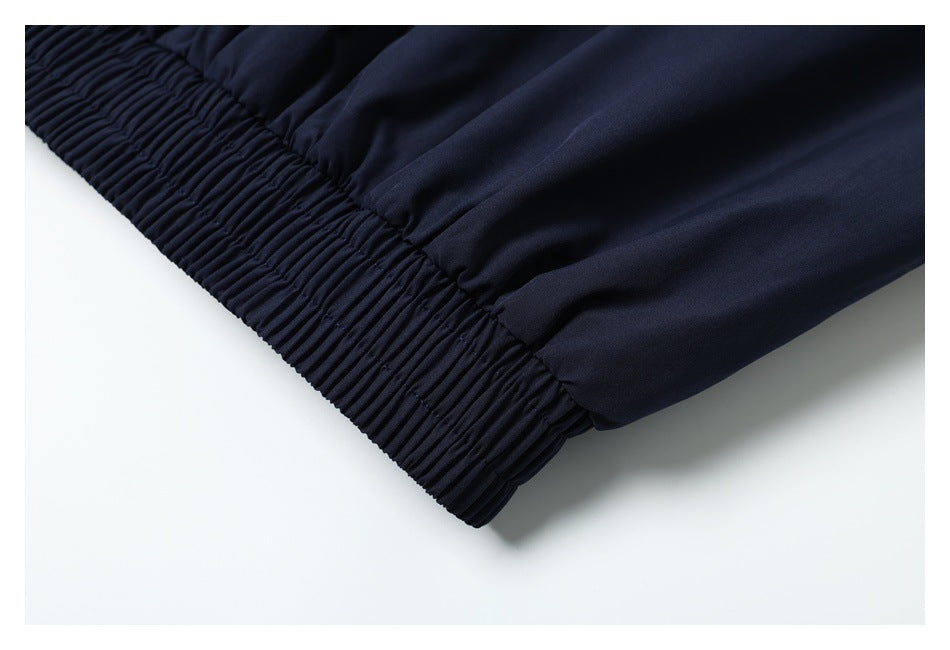 Close-up of a dark navy garment's gathered elastic hem.