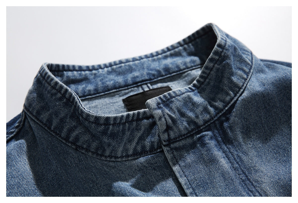 Close-up of a blue denim jacket's stand collar and front placket.