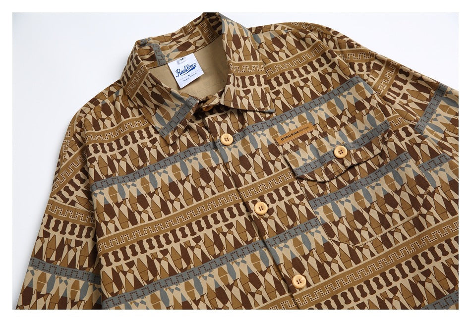 Close view of a brown geometric-print button-up shirt with a pointed collar, chest pocket and tan buttons.