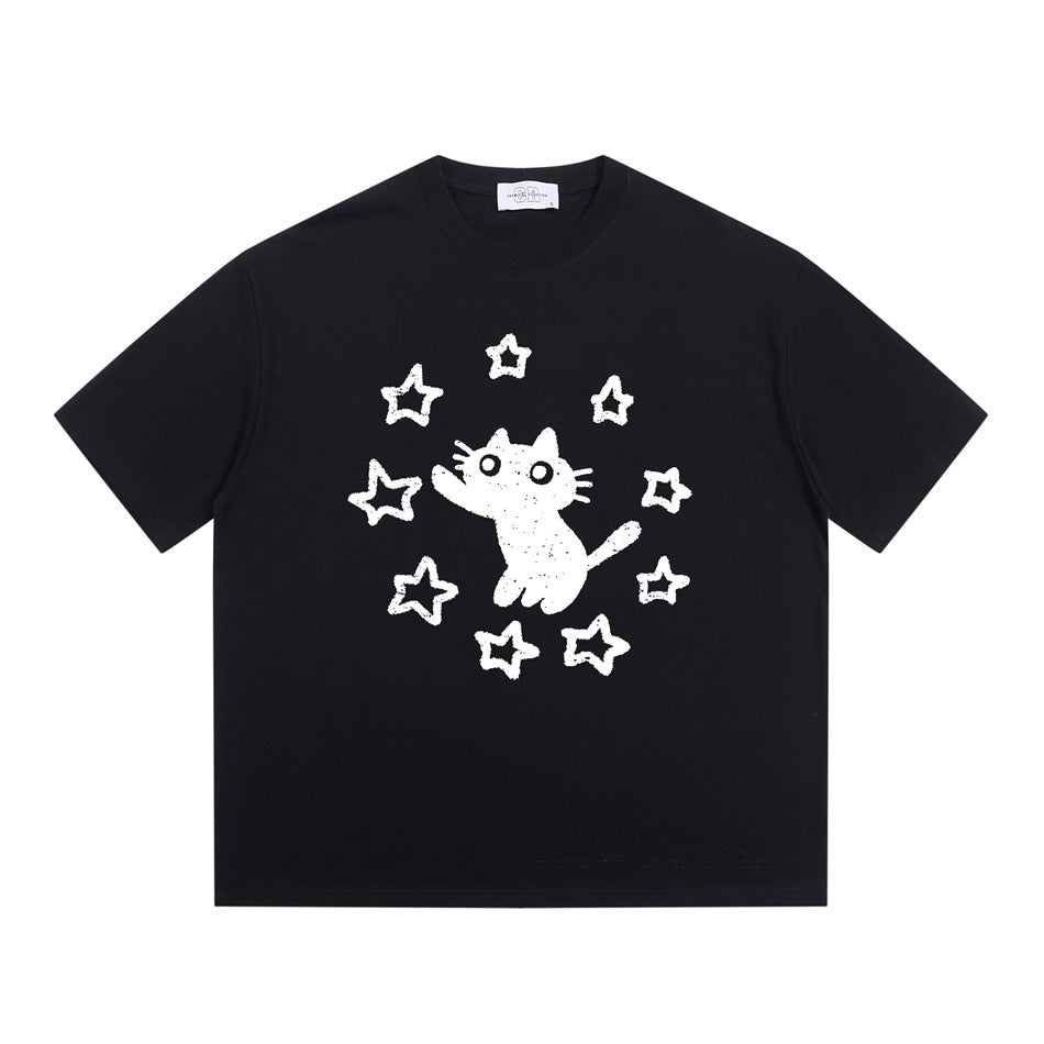 Black short-sleeve crew-neck T-shirt with a white cat and stars graphic on the chest, flat lay