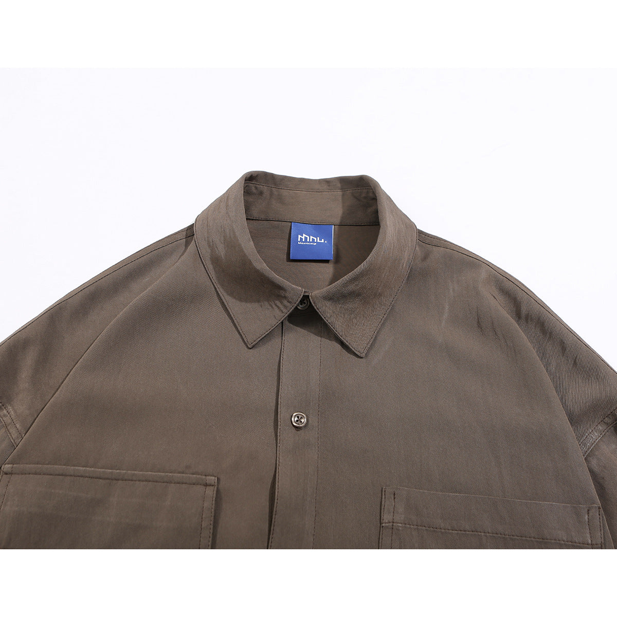 Close-up of a brown button-up shirt collar, front placket, and upper chest pockets.