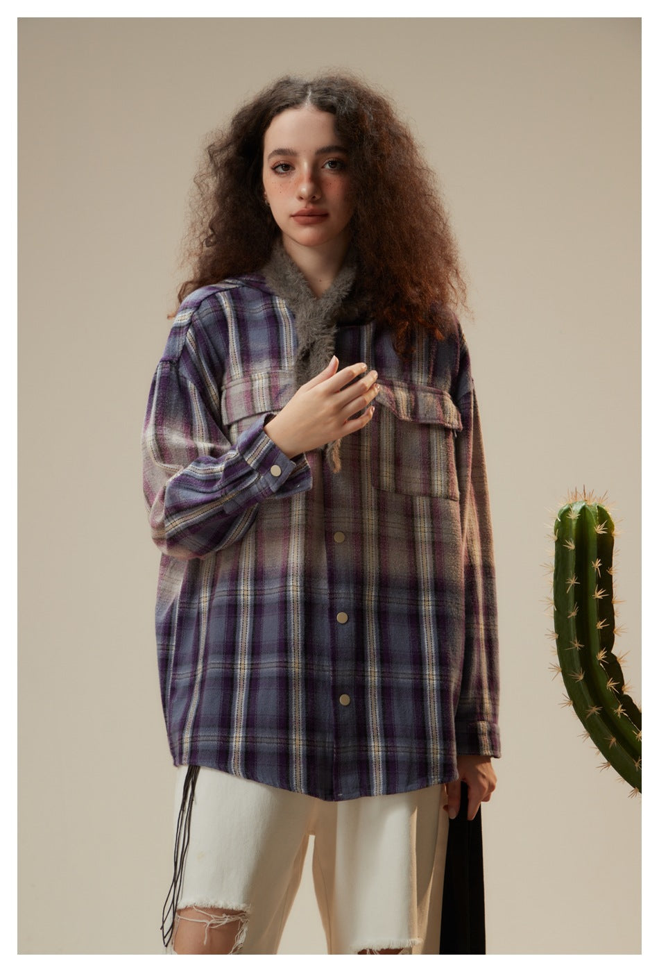 Close-up of model in oversized purple plaid hooded shirt jacket with chest flap pockets and snap buttons