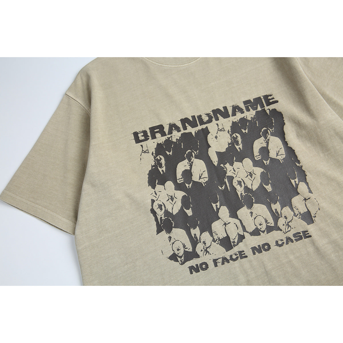 Close-up of a beige T-shirt front with a black crowd graphic and the words “BRANDNAME” and “NO FACE NO CASE.”