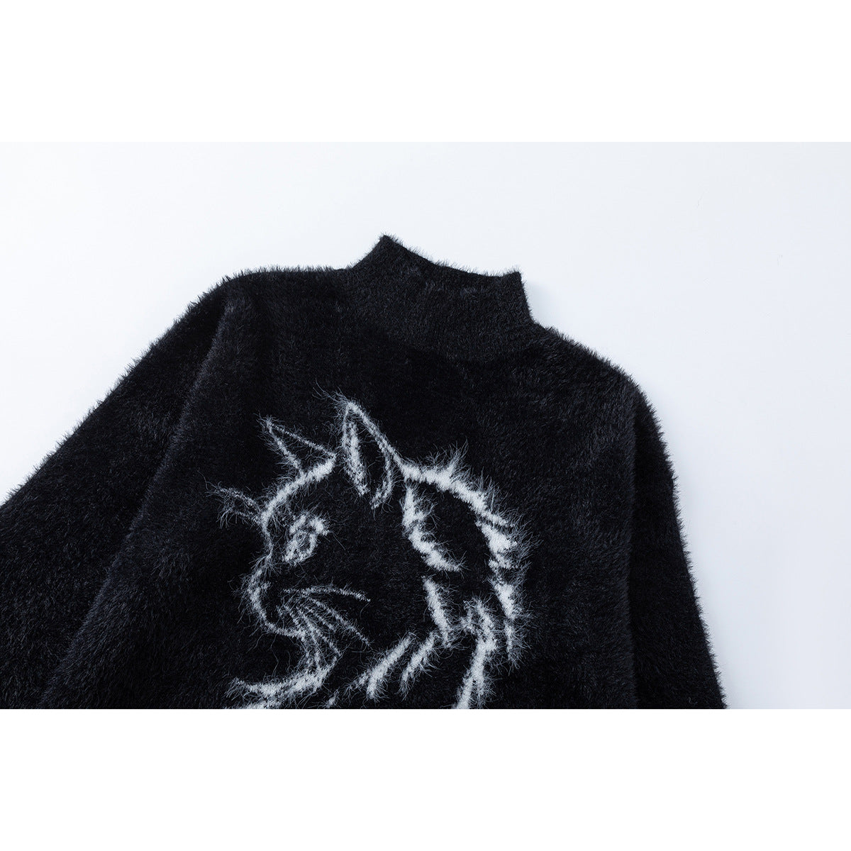 Close-up of a black fuzzy high-neck sweater with a white cat illustration on the front.