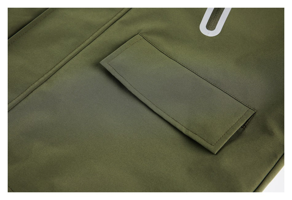 Close-up of an olive garment's rectangular flap pocket and white outlined accent.