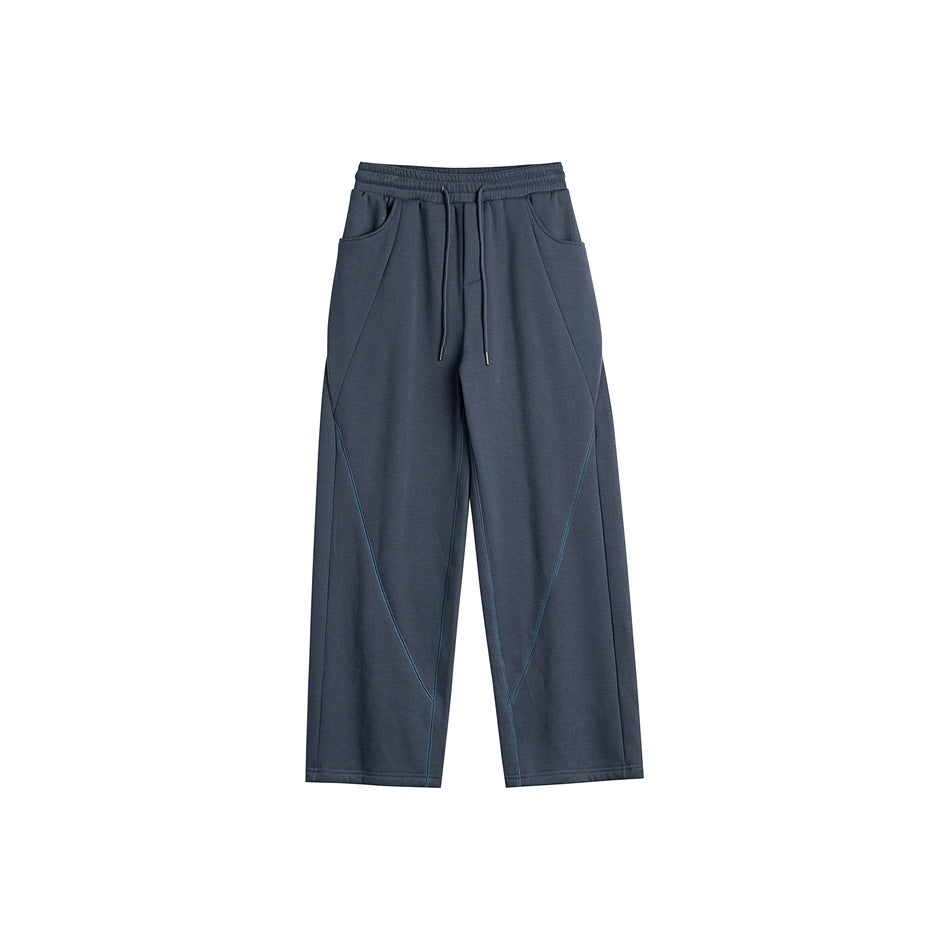 Dark slate blue-gray wide-leg drawstring sweatpants with diagonal tonal seam lines, front flat view