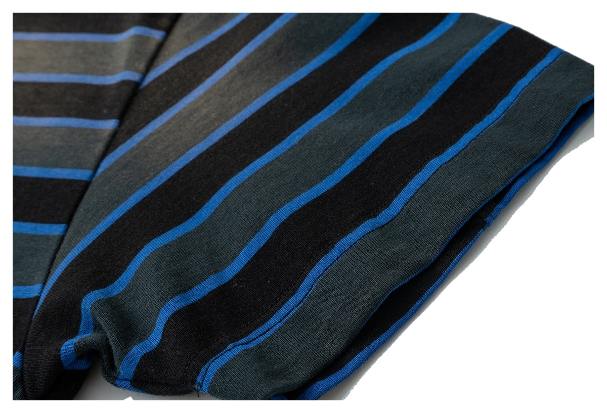 Close-up of the striped shirt sleeve and edge, showing black, charcoal, and bright blue bands.
