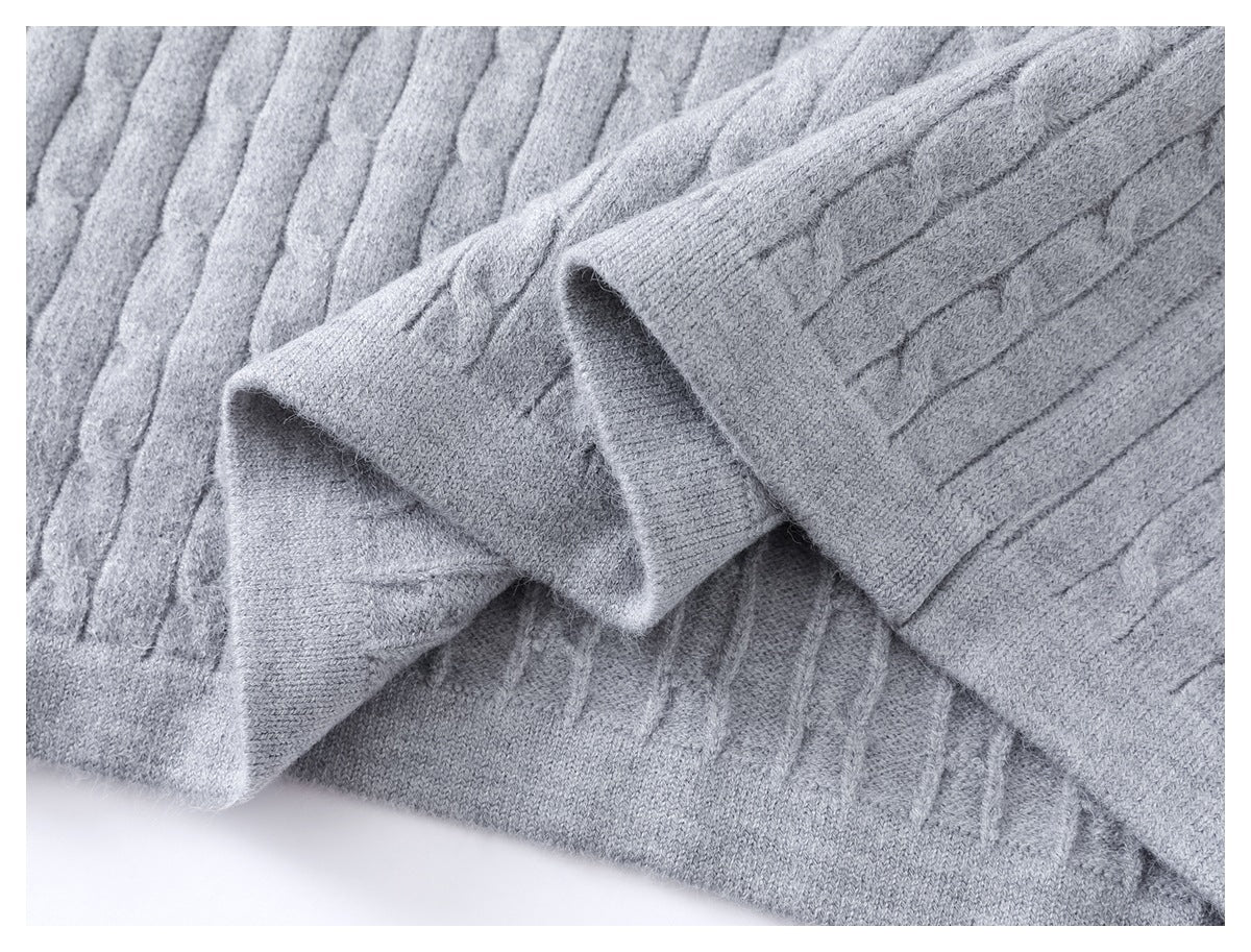 Close-up of the light gray cable-knit sleeve and ribbed cuff.