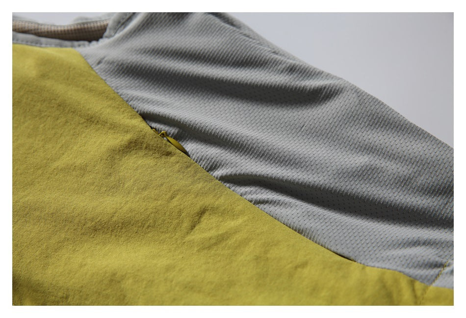 Close-up of a mustard-yellow garment panel beside gray perforated lining.