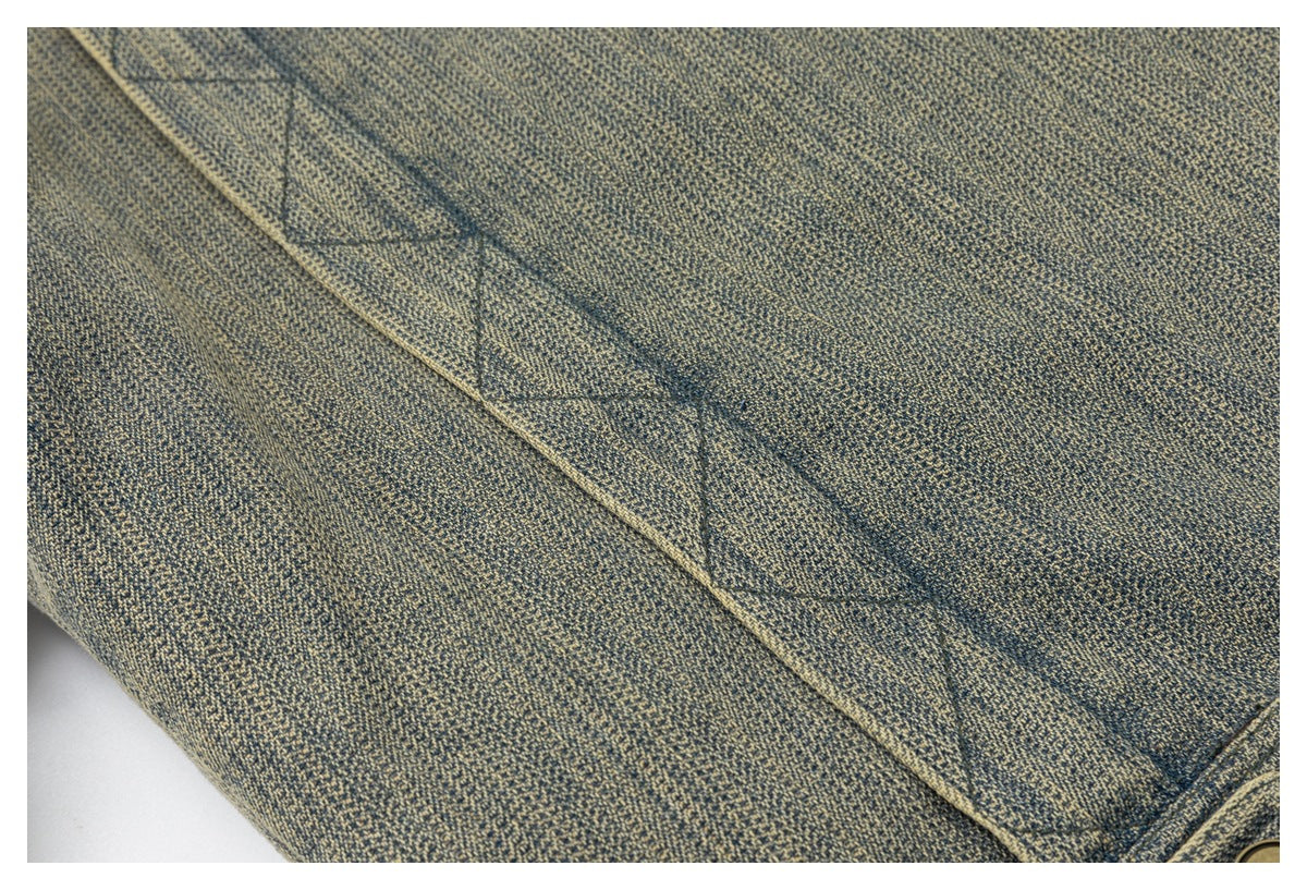 Close-up of the jacket's blue-gray textured fabric and diagonal stitched seam.