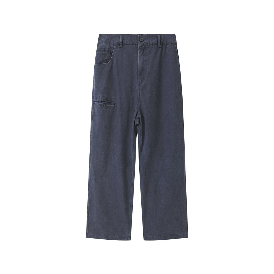 Front view of slate blue straight-leg pants with button waist, belt loops and diagonal zip-style leg pocket