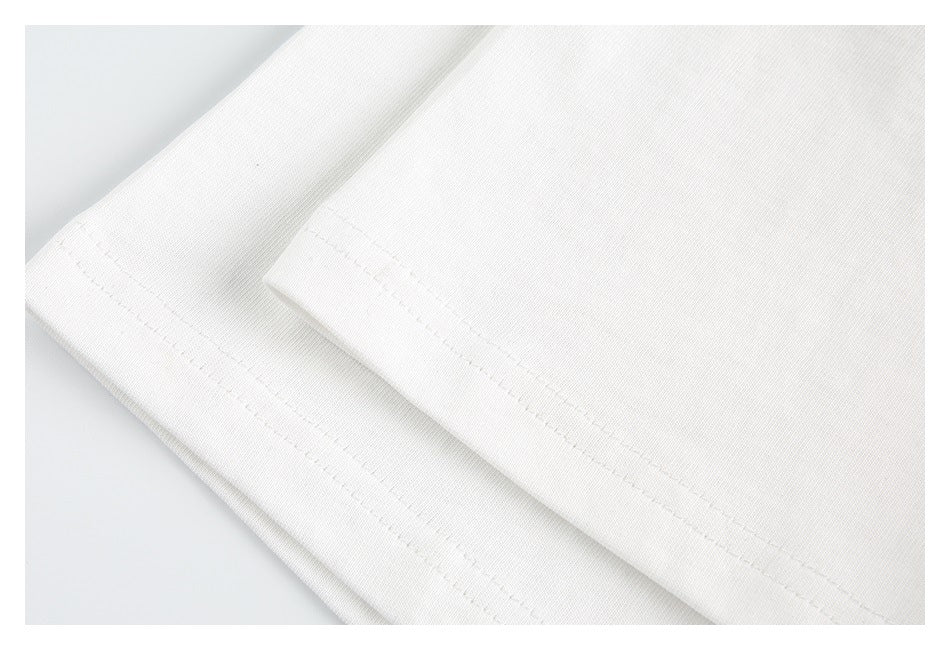 Close-up of white fabric with a folded edge and parallel rows of stitching.