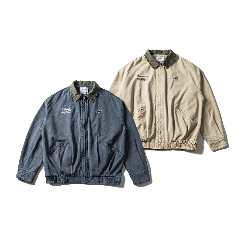 Two front-view jackets with contrast dark collars and embroidered chest details, shown in beige and blue-gray.
