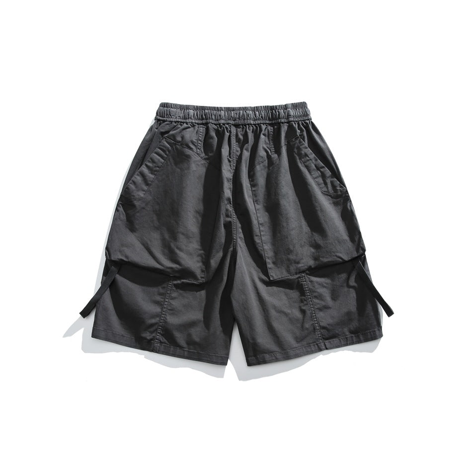 Charcoal gray cargo shorts laid flat, showing an elastic waistband and large front pockets.