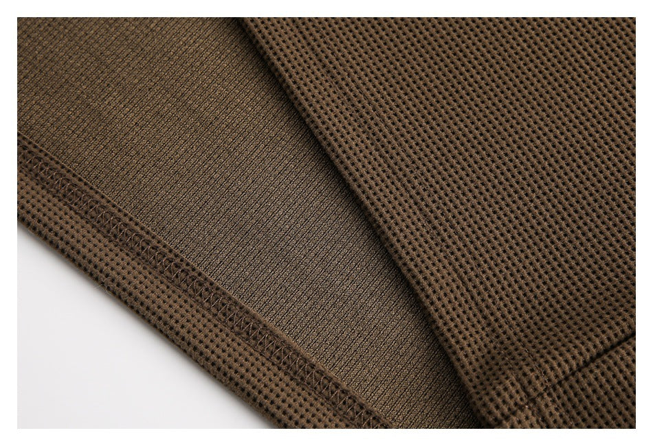 Close-up of the brown waffle-knit garment's inner surface and stitched seam.
