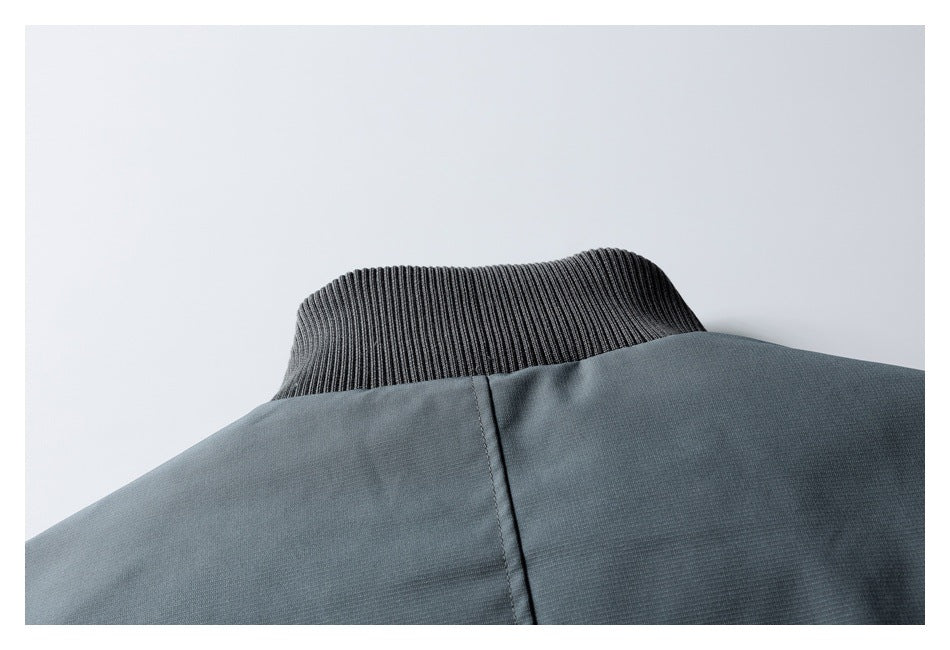 Close-up of the slate-gray jacket's ribbed stand collar and upper back seam.