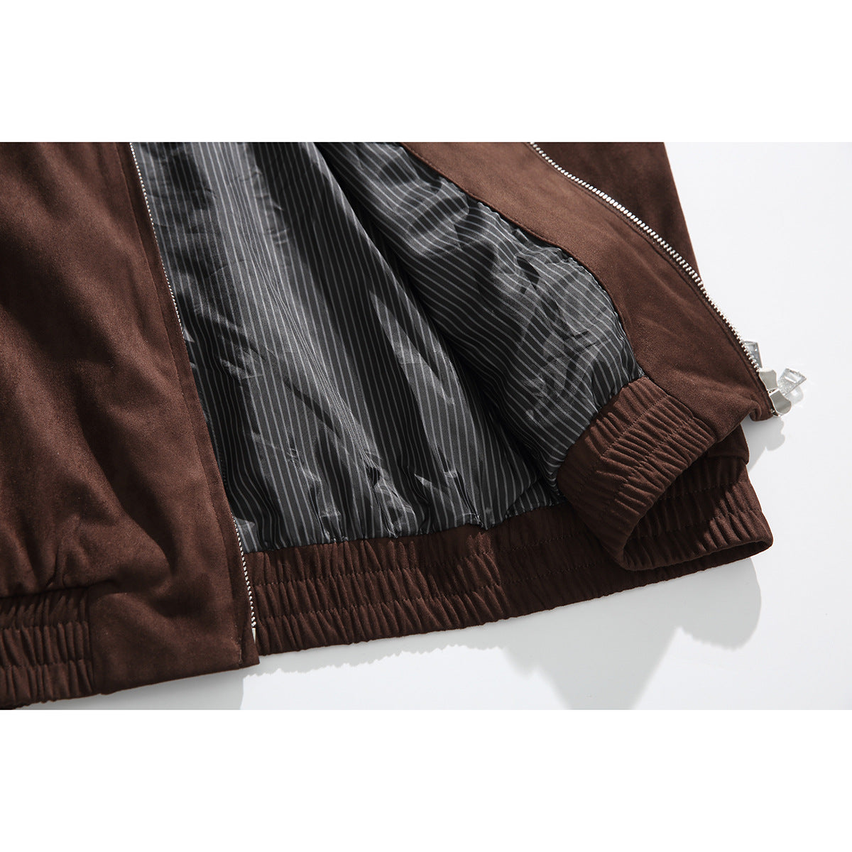 Close-up of the open dark brown jacket, showing its gray pinstriped lining and gathered hem.