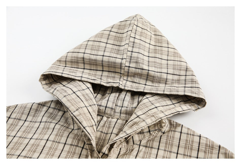 Close-up of the cream plaid shirt's hood, showing its seams and inner lining.