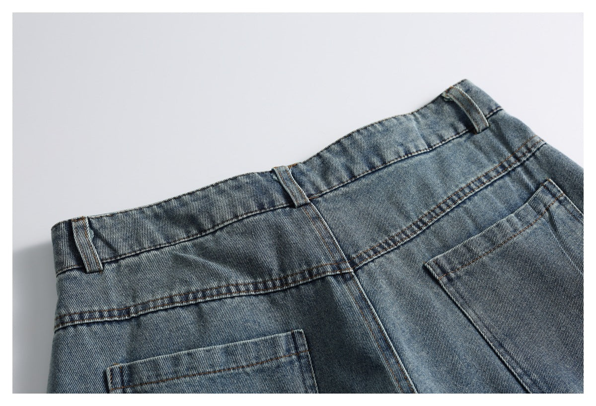 Close-up of the back waistband and belt loops of blue jeans, with part of the rear pockets visible.