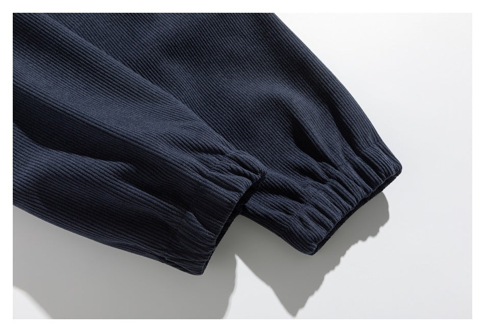 Close-up of a navy sleeve ending in a gathered elastic cuff.