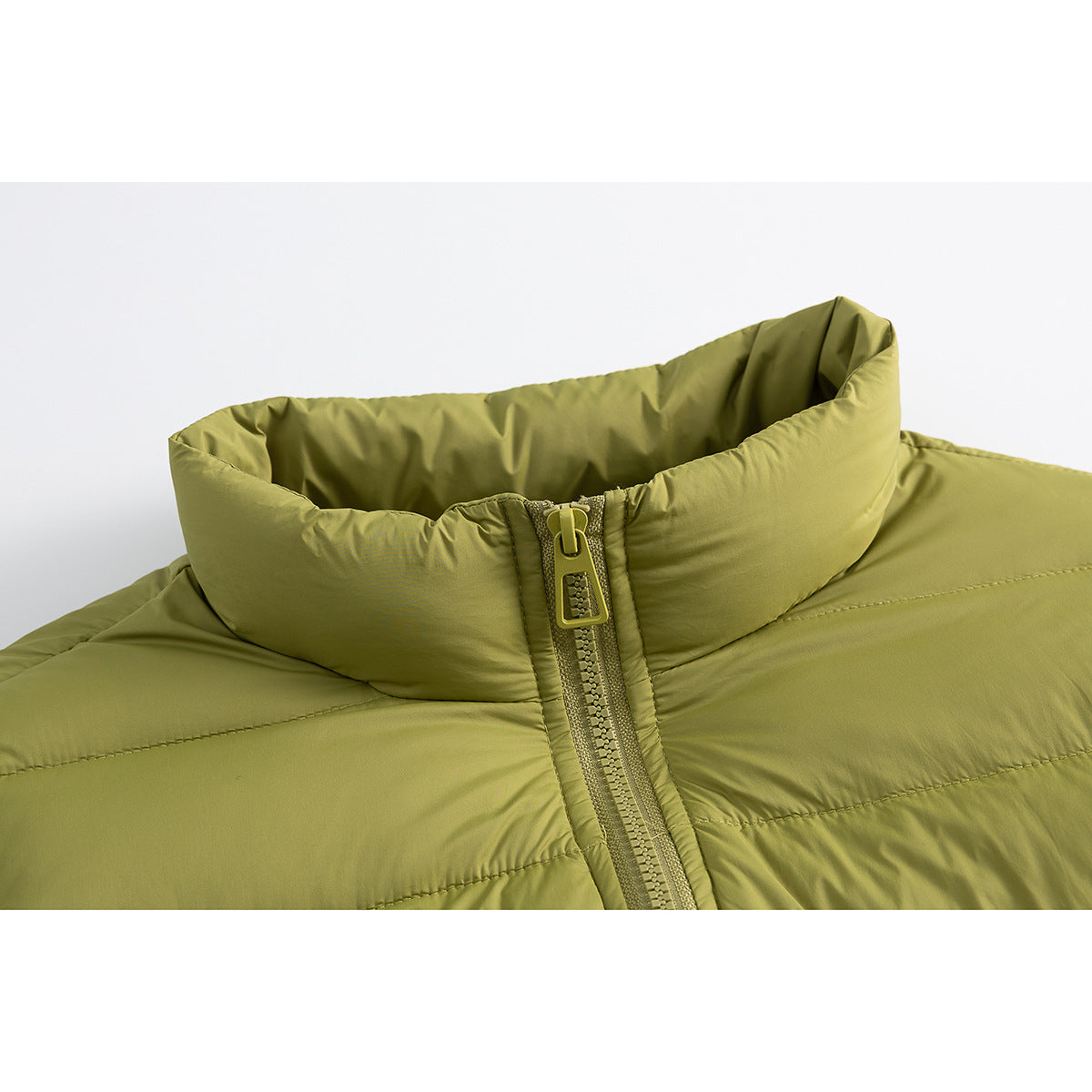 Close-up of an olive-green padded jacket's high collar and front zipper.