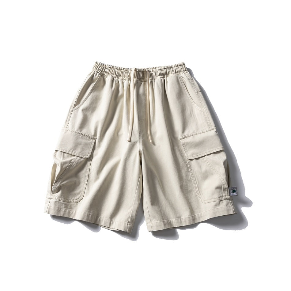 Off-white cargo shorts flat lay with drawstring elastic waist and large flap side pockets