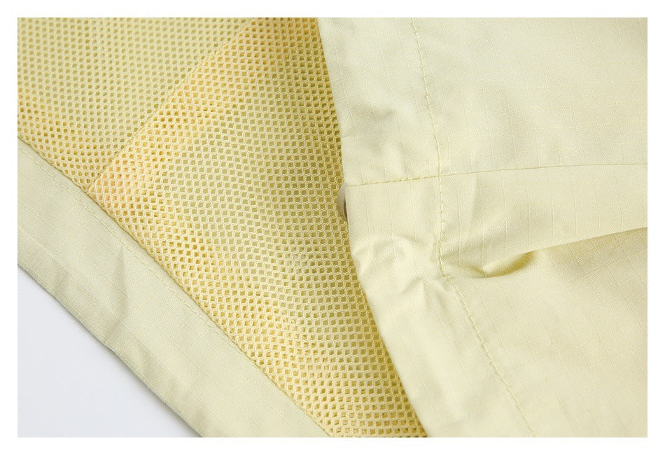 Close-up of pale yellow garment fabric beside a honeycomb mesh lining panel.