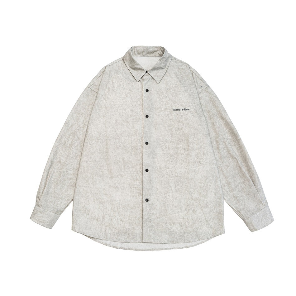 Front view of a light gray, mottled long-sleeve button-up shirt with a pointed collar and small chest lettering.