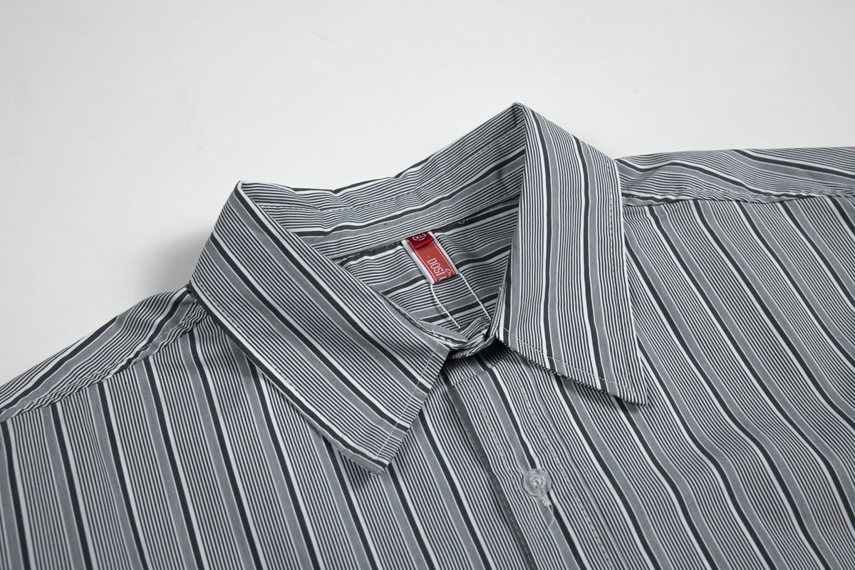 Close-up of the gray striped shirt's pointed collar, button placket, and sewn-in neck label.