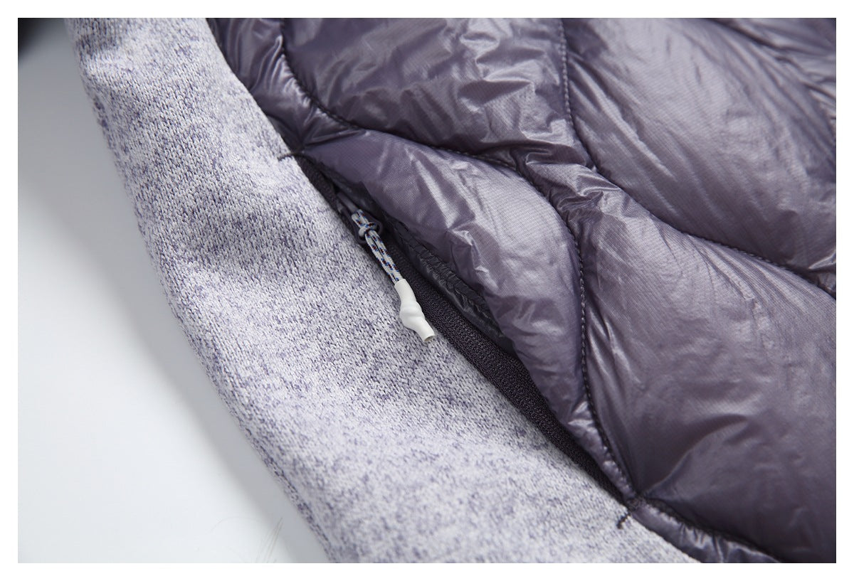 Close-up of a pocket zipper and pull between the jacket’s gray marled knit and plum quilted panels.