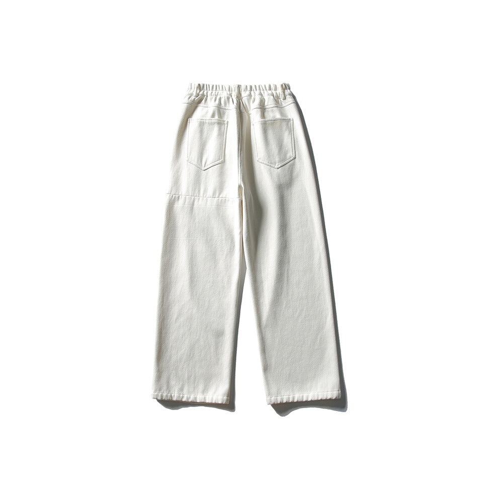 Back view of off-white wide-leg pants with elastic waistband, two patch pockets and horizontal seam on legs
