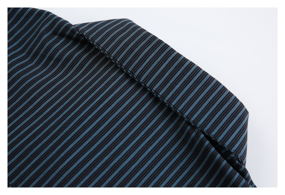 Close-up of dark fabric with narrow blue and black stripes and a curved stitched seam.