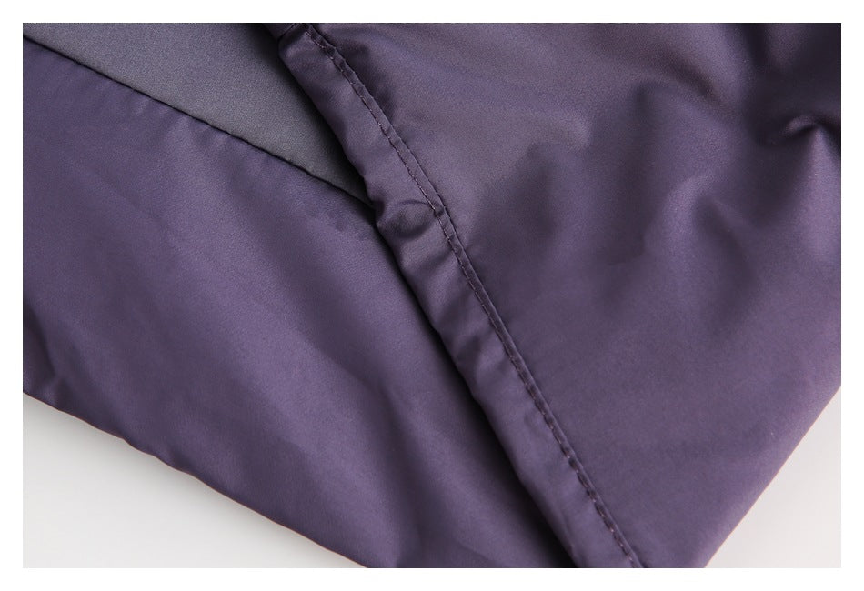 Close-up of a stitched seam on purple garment fabric.