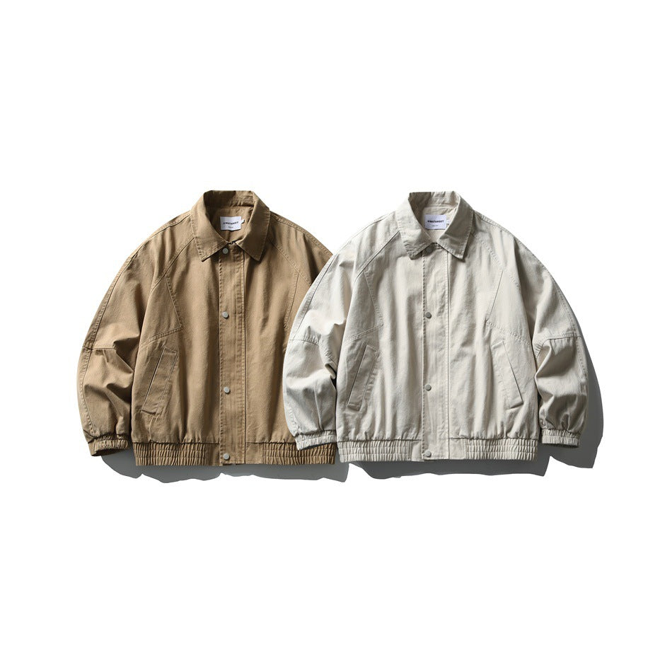 Front view of two collared jackets with snap fronts and elastic hems, in tan and off-white.