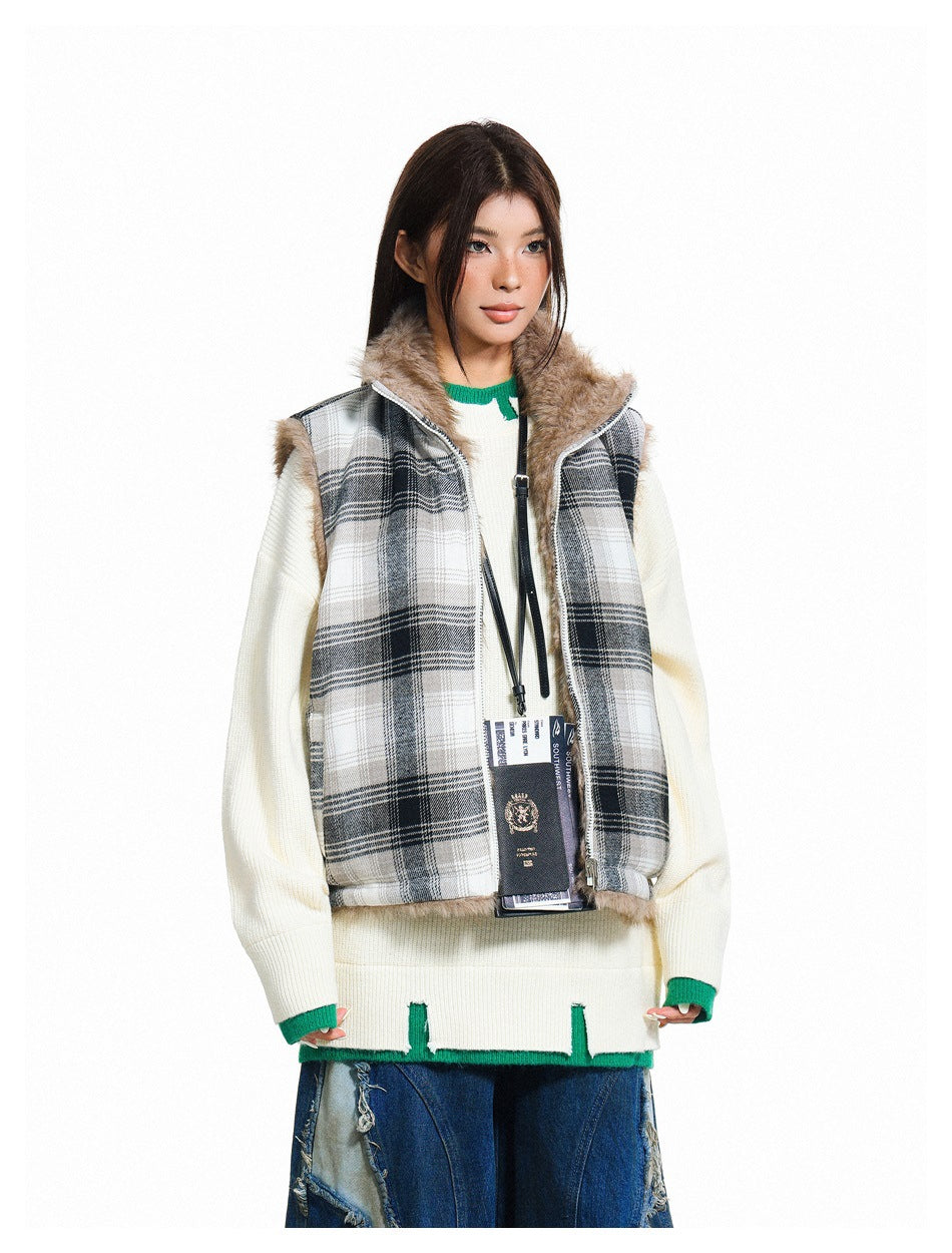 Model wearing the black plaid vest open over a cream knit sweater, showing the plush pile collar and interior